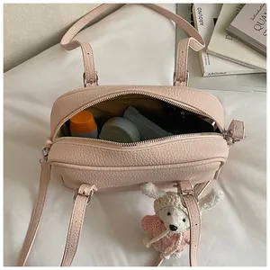Internal view of pink lychee leather bag showing capacity for phone and cosmetics