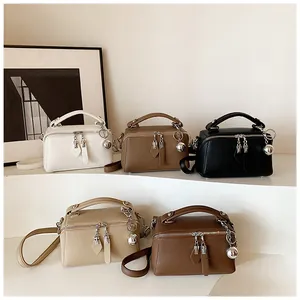 Detailed display of assorted Boston bags in pebbled leather with dual zip closure