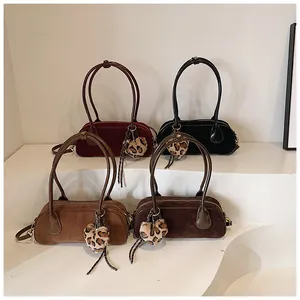 Detailed view of matte shoulder bags in four colors with leopard heart plush charms