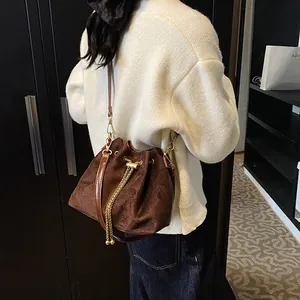 Brown vintage velvet drawstring bucket bag with gold chain tassels for casual wear
