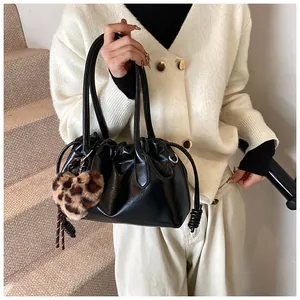 Détail du sac à main noir en cuir PU à cordon avec un pendentif cœur léopard chic