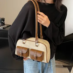 Retro canvas and brown leather shoulder bag with front pockets on model