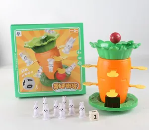 Close-up of carrot balance tower game with white rabbit figures and numbered dice for kids