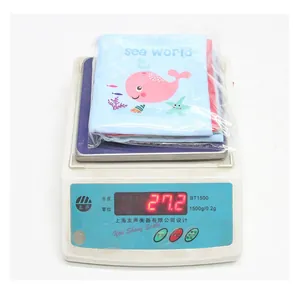 Weight measurement of sea world baby cloth book showing 27.2g on digital scale