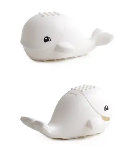 Detailed view of a white whale-shaped building block base with compatible studs