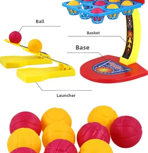 Close-up of tabletop basketball toy set including mini balls, launcher, and stand components