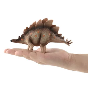 Detailed Stegosaurus dinosaur toy model held in hand showing realistic texture and size