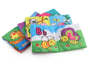 Macro view of stackable educational cloth books featuring colorful lion and monkey graphics
