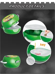 Detail of green dinosaur storage box showing building block lid and piggy bank coin slot