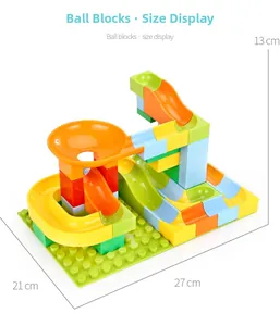 Dimensions display of colorful marble run building blocks with tracks and funnels on green base