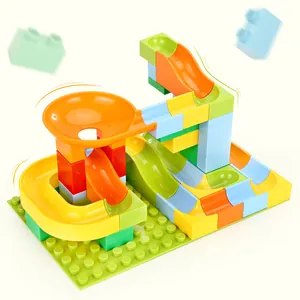 Colorful multi-level marble run toy with plastic tracks and blocks on a green baseplate