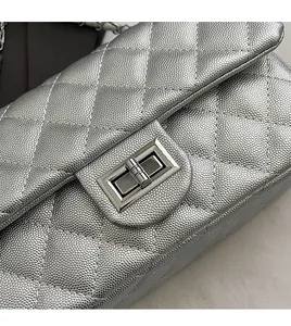 Close-up of metallic silver quilted caviar leather with a classic rectangular metal clasp
