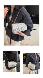 Macro detail of silver quilted chain bag featuring a metallic turn-lock and rhombic pattern