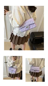 Close-up of light purple quilted crossbody bag with metal lock and chain strap detail