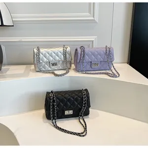 Detailed view of quilted crossbody chain bags in silver, lavender, and black faux leather