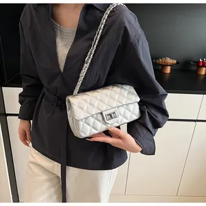 Silver quilted chain bag crossbody style shown on model in a modern indoor setting