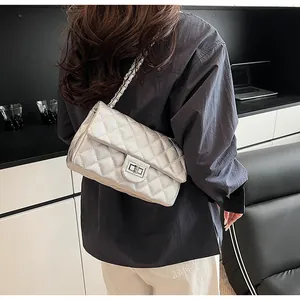 Silver quilted chain strap crossbody bag with metallic finish and metal turn-lock