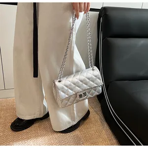 Detail of silver quilted leather bag showing the shiny metallic texture and metal twist lock