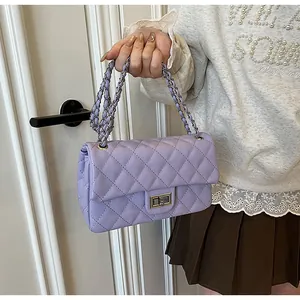 Close-up of light purple quilted shoulder bag with silver turn-lock and chain strap