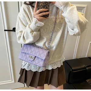 Close-up of lavender quilted rhombic cross-body bag with silver metal turn-lock
