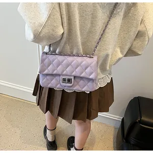 Detail of lavender quilted crossbody bag with silver twist-lock and metal chain strap
