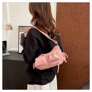 Detailed view of pink multi-pocket faux leather shoulder bag in vintage Y2K style
