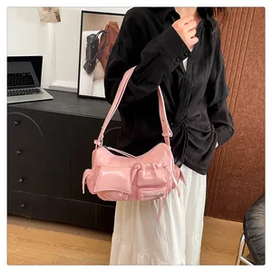 Detailed view of pink multi-pocket faux leather shoulder bag with zipper decorations