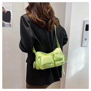 Detail view of lime green multi-pocket crossbody bag in vintage oil wax leather
