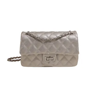 Champagne gold quilted crossbody bag with metal chain strap and turn-lock closure