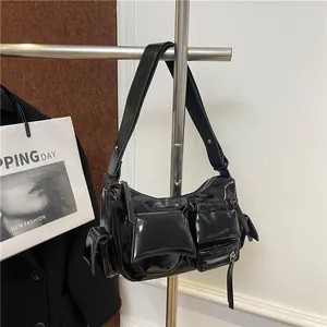 Chic black patent leather multi-pocket biker bag with adjustable shoulder strap