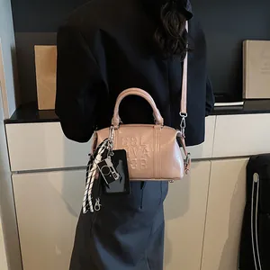 Pink bowling handbag with 3D embossed letters and decorative scarf in street style