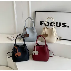 Litchi pattern leather bucket bags with elephant charms in four various colors