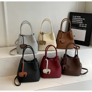 Litchi pattern bucket bags in six colors with leather elephant charms and shoulder straps