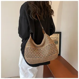 Close-up of deep brown straw bag with diamond hollow weave and leather strap detail