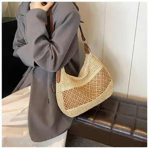Detail of hand-woven straw hobo bag showing contrast mesh texture and leather handle