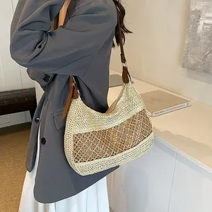 Minimalist straw hobo shoulder bag with brown leather strap for summer beach holidays
