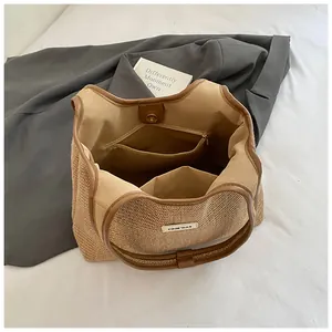Minimalist straw tote bag with brown leather trim and spacious interior lining