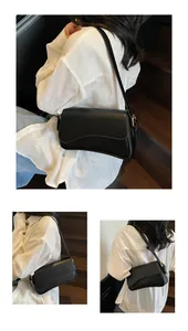 Détail du sac de selle noir avec rabat ondulé unique et finitions en métal doré élégantes