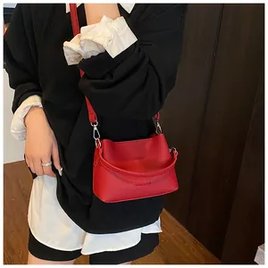 Vue détaillée du sac seau rouge en cuir grainé avec inscription Fashion & Bags