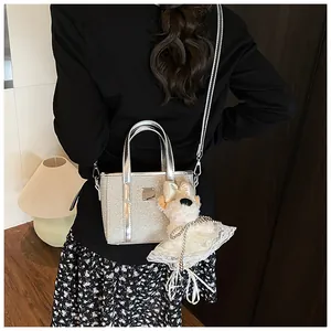 Close-up of silver sequin tote bag with elegant metallic handle and cute puppy charm