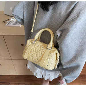 Dettaglio della borsa trapuntata giallo chiaro con strass luccicanti e fibbie argentate