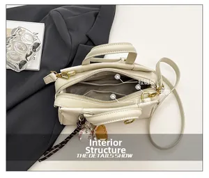 Detail view of the bag's interior structure with zipper pocket and baseball charm
