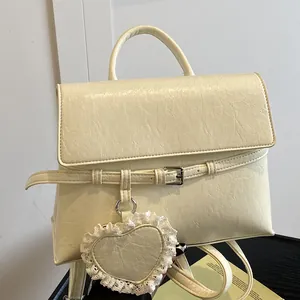 Chic cream leather backpack for women with heart pendant and adjustable straps