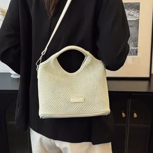 Chic cream mesh woven tote bag with adjustable shoulder strap and leather logo patch