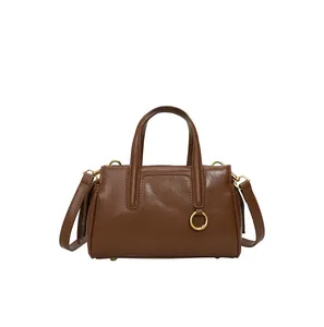 Brown vintage glossy leather tote bag with gold ring hardware and crossbody strap