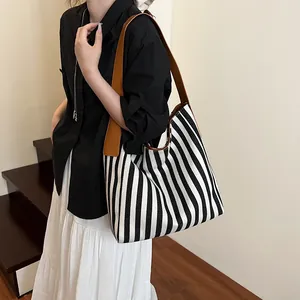 Large striped canvas tote bag with brown shoulder straps for casual daily commuting