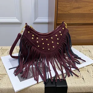 Burgundy suede fringe crossbody bag with gold rivets and bohemian tassel detailing