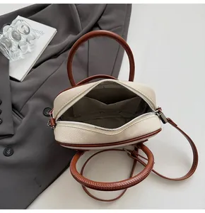 Detailed interior of the beige canvas Boston bag with inner pocket and zipper closure