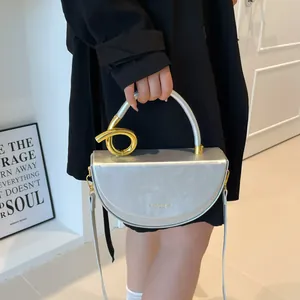 Silver crescent moon shoulder bag with mixed metal gold and silver handle for women