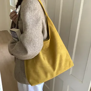 Large yellow matte faux suede tote bag with wide shoulder strap for everyday commute